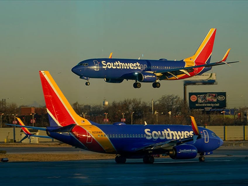 A Southwest Airlines plane prepares to land at Midway International Airport while another