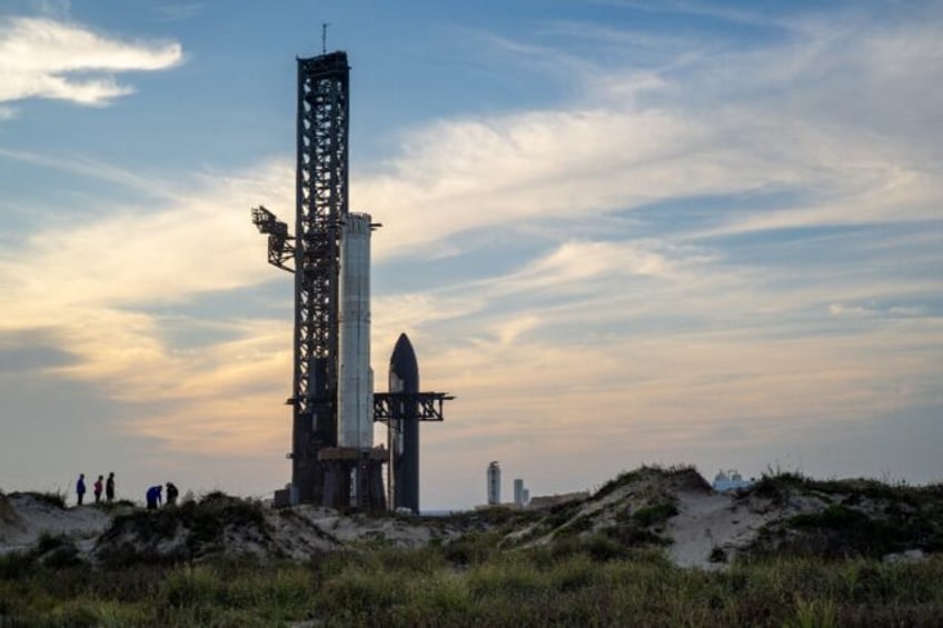 People view SpaceX Starship Flight 8 as it is stationed near Orbital Launch Pad A ahead of