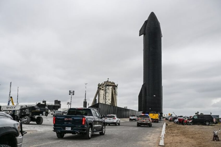 People gather as SpaceX Starship spacecraft prototype is transported from the launch site