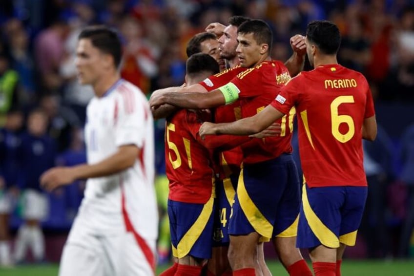 Spain players celebrate after beating Italy 1-0 in Gelsenkirchen to clinch a place in the