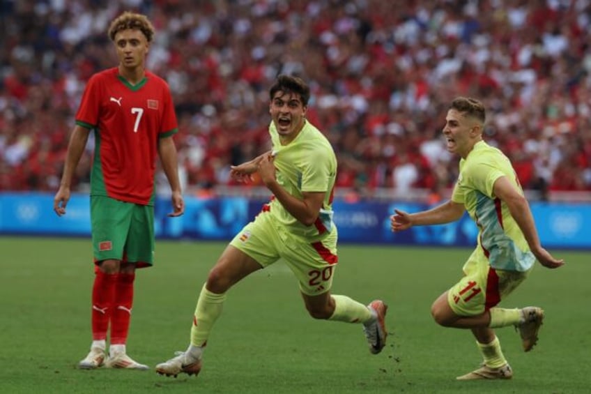 Juanlu Sanchez (C) celebrates with Fermin Lopez after scoring Spain's winning goal against