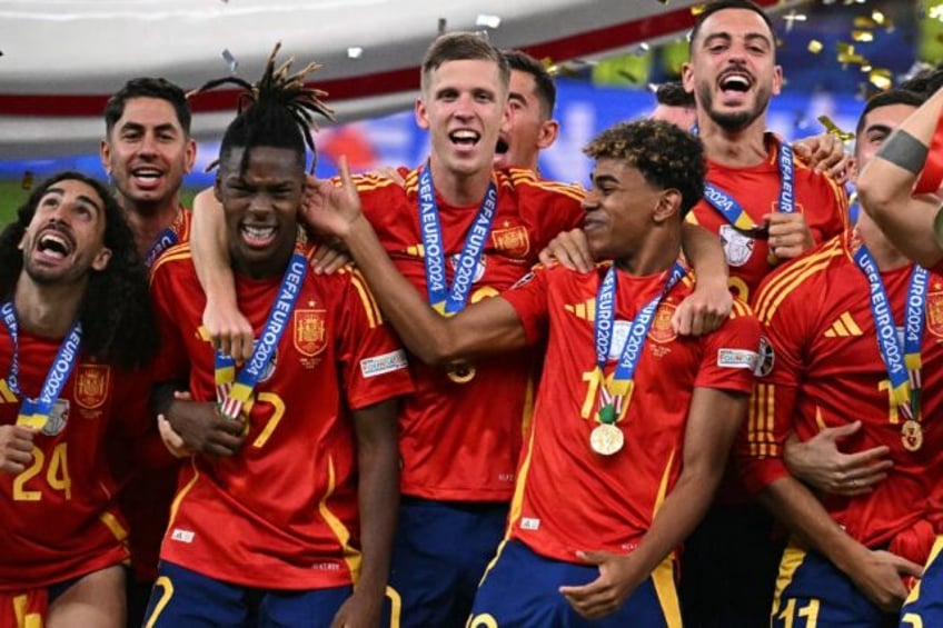 Spain midfielder Nico Williams (3L) and Spain forward Lamine Yamal (C) celebrate after win