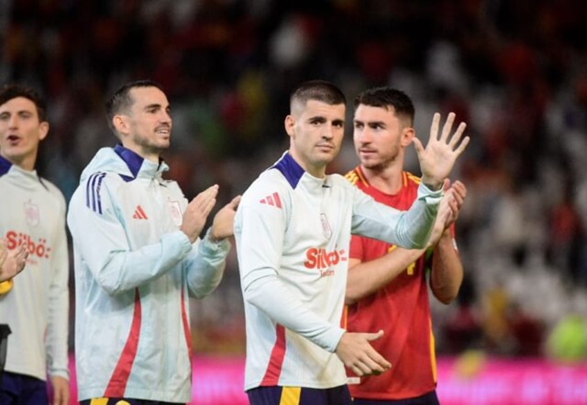 Spain's Fabian Ruiz, Alvaro Morata and Aymeric Laporte celebrate after beating Serbia 3-0