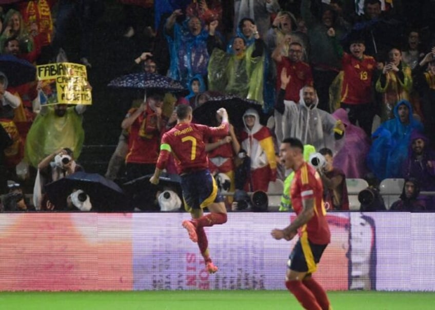 Spain forward Alvaro Morata celebrates with supporters after scoring his team's second goa