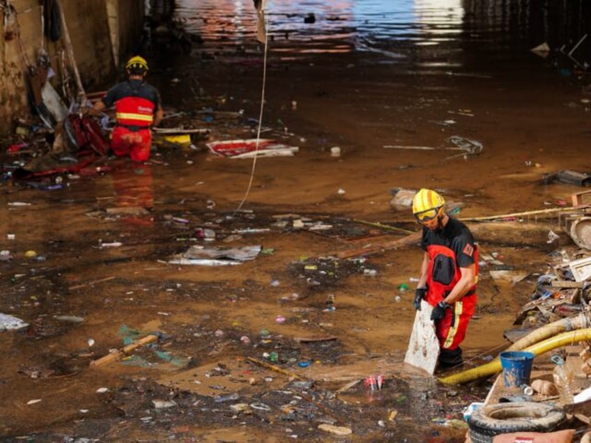 Firefighters search for bodies amongst the debris on November 2, 2024, in the aftermath of