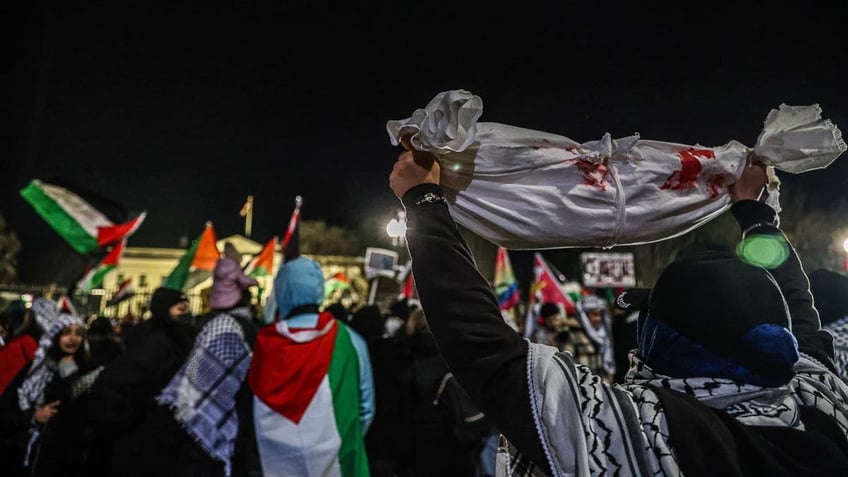 Protestor holding up bloody fabric