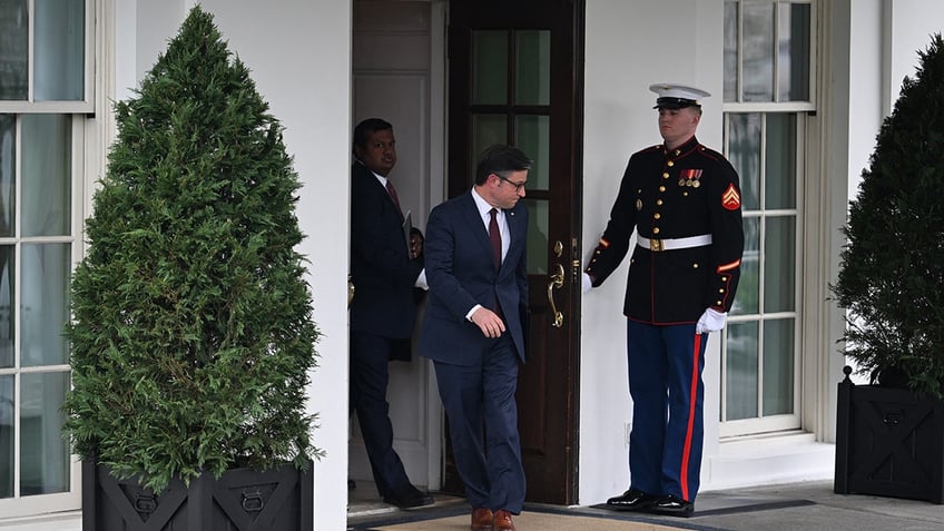 Speaker Johnson leaves the White House followed by a top aide