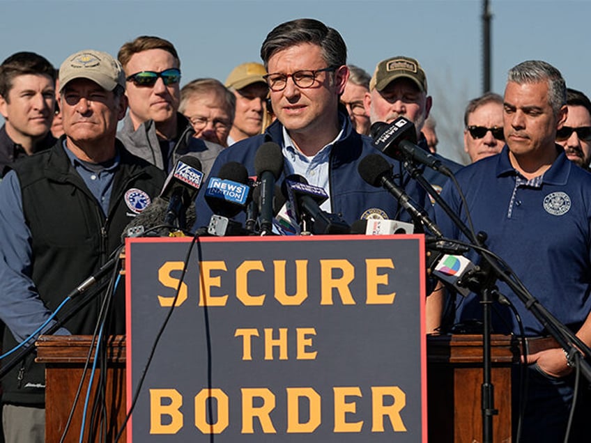 U.S. House Speaker Mike Johnson speaks while standing with Republican members of Congress,