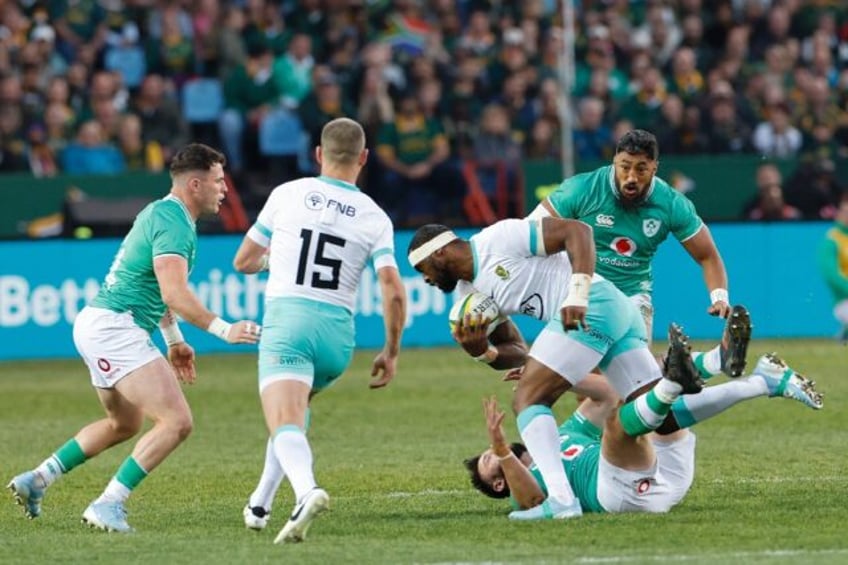 South Africa captain Siya Kolisi (C) runs with the ball during the first Test against Ire