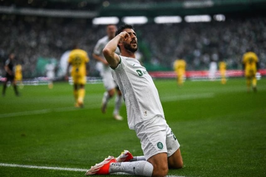 Sporting's Portuguese forward Paulinho celebrates scoring on Saturday with his team's titl