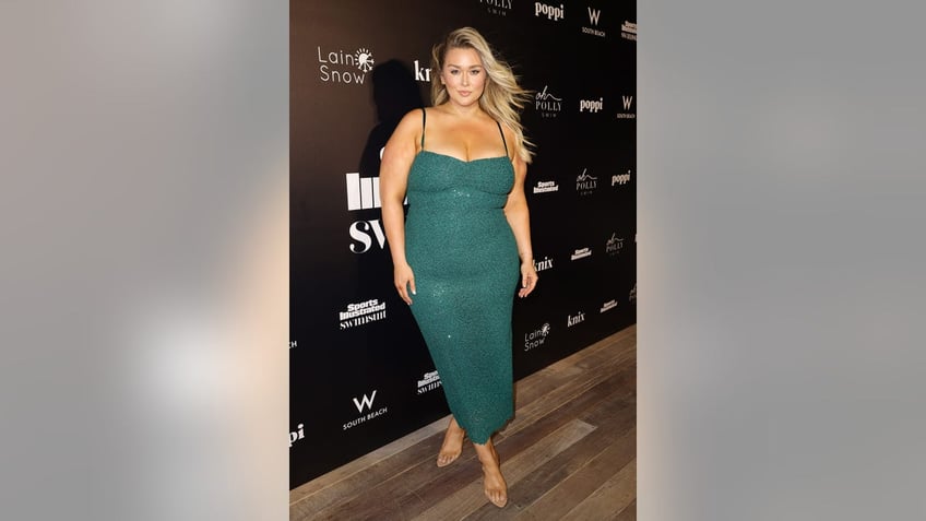 Hunter McGrady wearing a spaghetti strap sea green sparkling dress