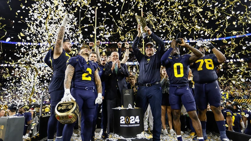 Jim Harbaugh hoists trophy