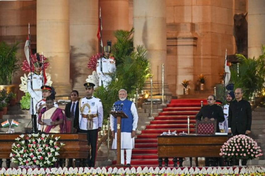 Indian Prime Minister Narendra Modi takes the oath of office at the presidential palace;