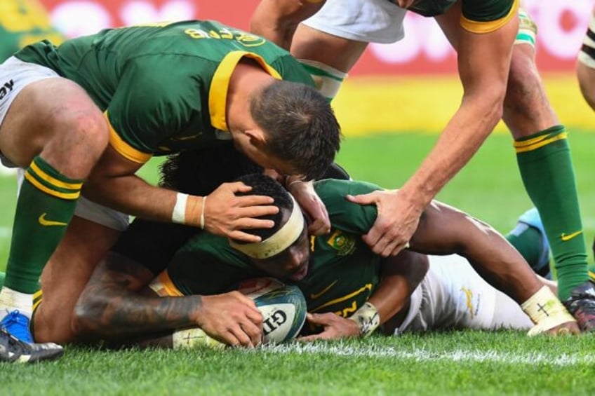 South Africa captain Siya Kolisi (C) is congratulated after scoring against New Zealand