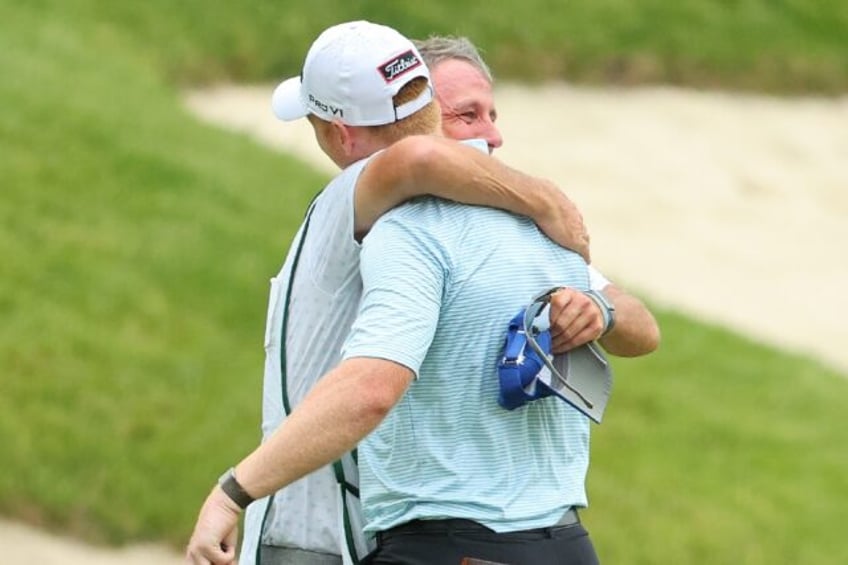 Hayden Springer (right) celebrates with his caddie after a last-hole birdie saw him comple