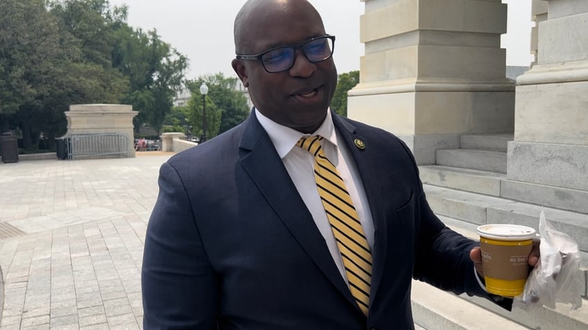 Jamaal Bowman outside Capitol holding coffee cup