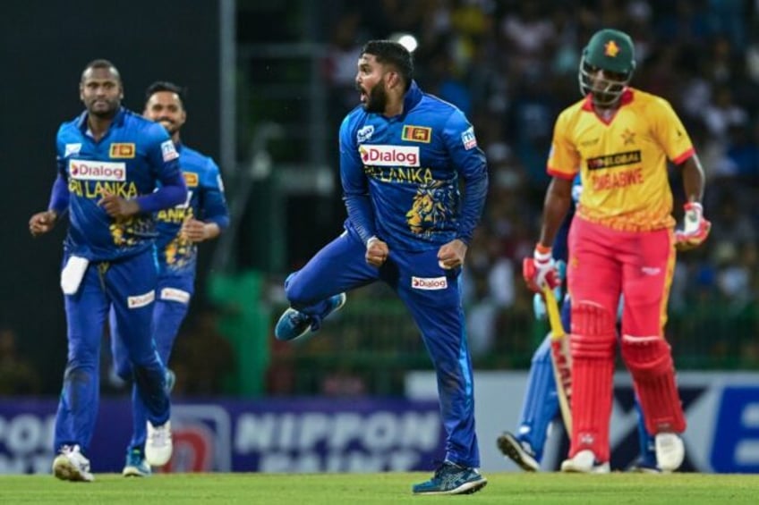 Sri Lanka's Wanindu Hasaranga (2R) celebrates taking the wicket of Zimbabwe's Richard Ngarava (R) in the third and final Twenty20 international in Colombo