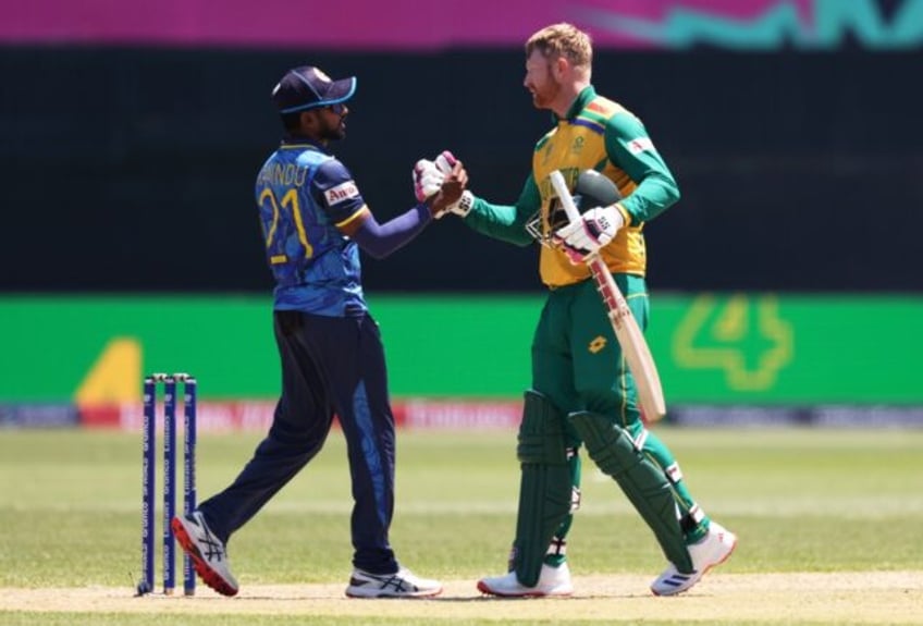 Heinrich Klaasen of South Africa and Wanindu Hasaranga of Sri Lanka shake hands following