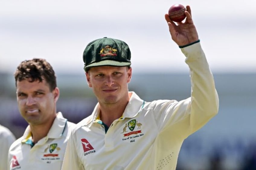 Australia's Matthew Kuhnemann (R) celebrates his five-wicket haul in the first Test agains