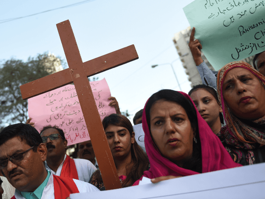 Pakistani Christians hold placards and cross during a protest in Karachi on April 27, 2019, against the suicide bomb attacks in Sri Lanka. - Fifteen people including six children died in a battle between Sri Lankan security forces and suicide bombers who blew themselves up in the latest fallout from the Easter attacks, police said. (Photo by RIZWAN TABASSUM / AFP) (Photo credit should read RIZWAN TABASSUM/AFP/Getty Images)