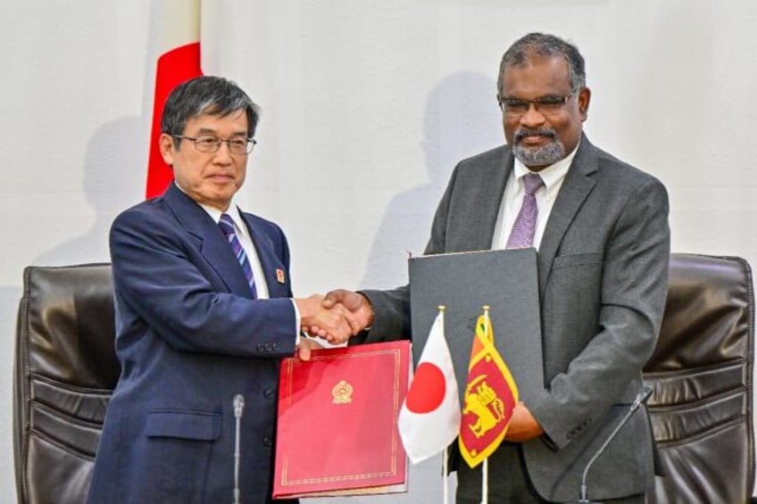 Japan's ambassador to Sri Lanka Akio Isomata (left) with Sri Lanka finance ministry secret