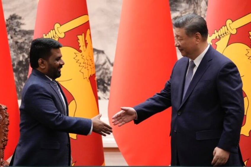 Chinese President Xi Jinping (R) shakes hands with Sri Lankan President Anura Kumara Dissa