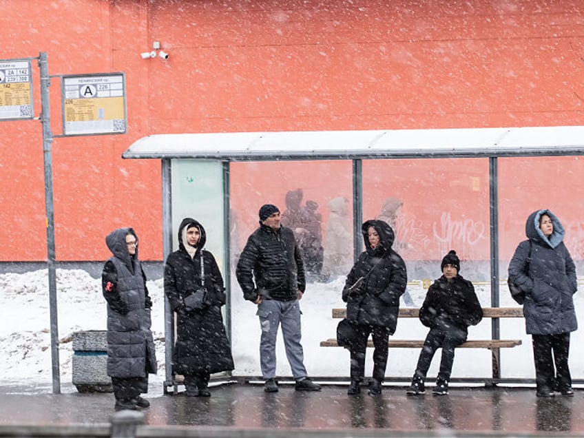 ST PETERSBURG, RUSSIA - 2023/12/21: People seen standing at a public transport stop during