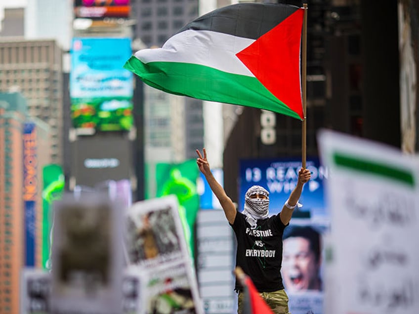 Members of the Palestinian community, fellow Muslims and their supporters rally in support of the Palestinian people in the wake of the recent violence in the Gaza Strip, during a rally in Times Square, May 18, 2018 in New York City. Israeli soldiers killed over 50 Palestinian protestors earlier this …