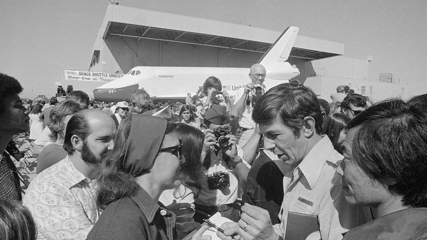 Leonard Nimoy signing autographs.