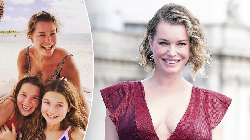 Rebecca Romijn smiles behind her two daughters split Rebecca Romijn in a burgundy short sleeve dress