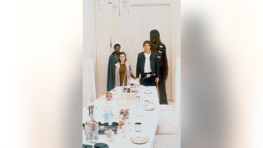 American actors Billy Dee Williams, Carrie Fisher, Harrison Ford and British Peter Mayhew on the set of Star Wars: Episode V - The Empire Strikes Back