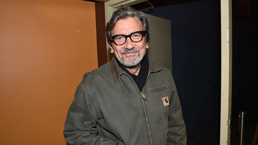 Griffin Dunne posing in doorway