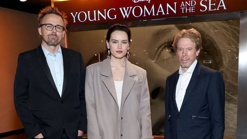 Joachim Rønning, Daisy Ridley and Jerry Bruckheimer posing together