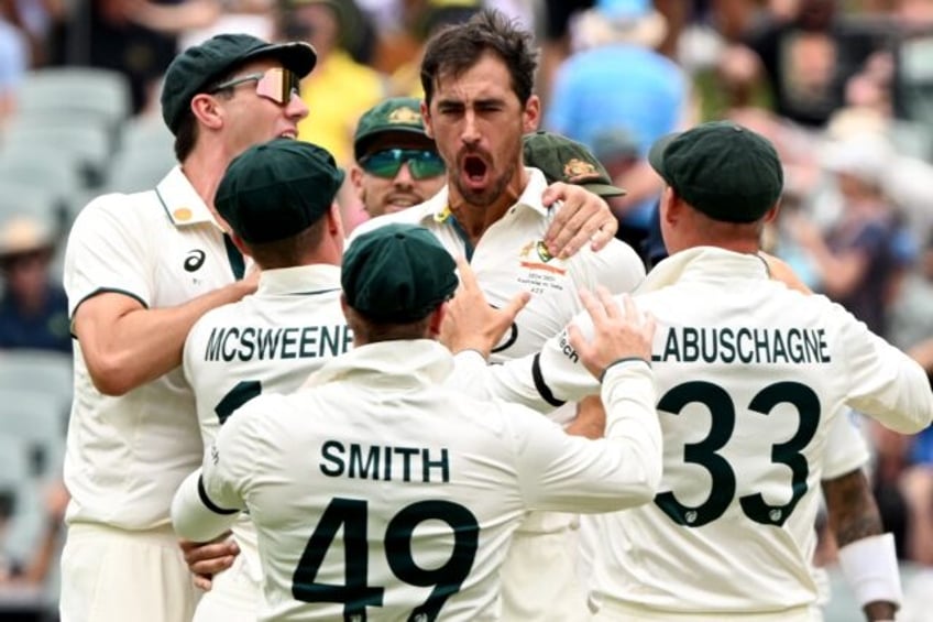 Australian bowler Mitchell Starc (C) celebrates the wicket of Indian batman Yashasvi Jaisw