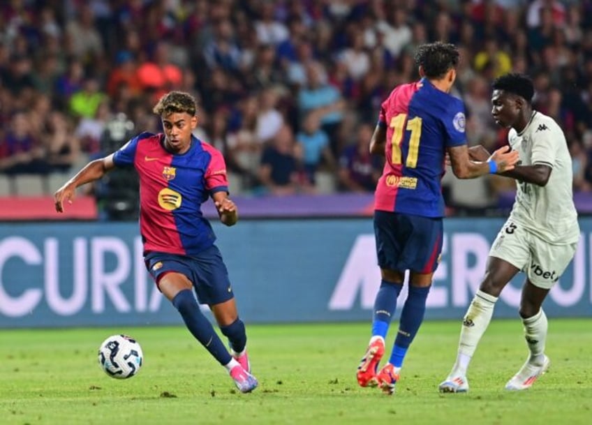 Barcelona's Spanish forward Lamine Yamal (L) has already become the team's key figure desp