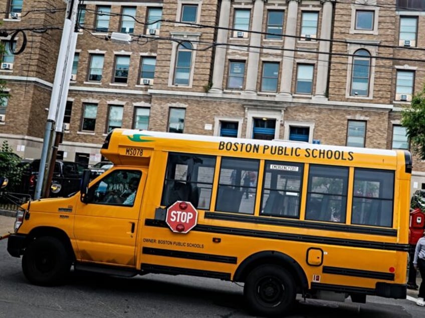 Boston, MA - June 7: A school bus waits outside of Excel Academy in South Boston (formerly