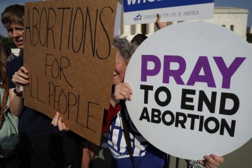 An anti-abortion activist and an abortion rights advocate during a rally outside the Supre