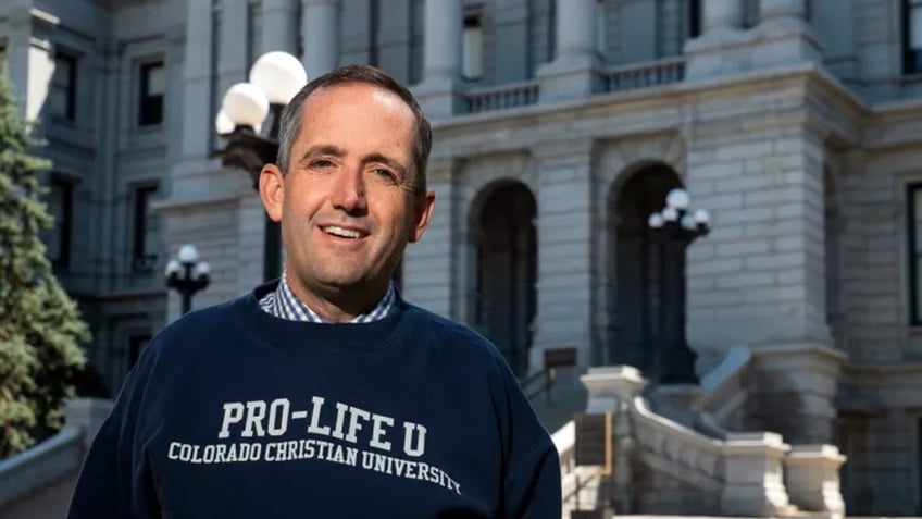 Jeff Hunt wears "Pro-Life U" sweatshirt in front of Colorado State Capitol