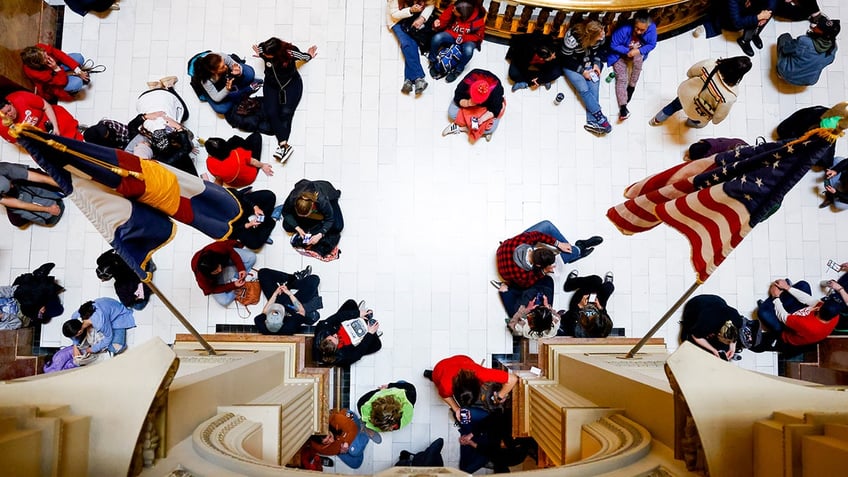 Students sit on floor of Colorado State Capitol