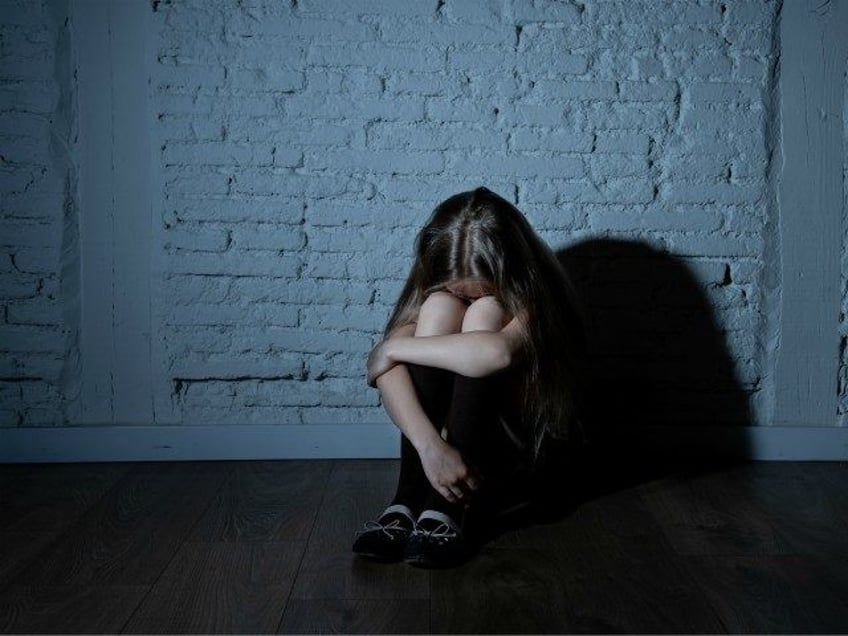 Sad desperate young girl suffering from bulling and harassment at school - stock photo