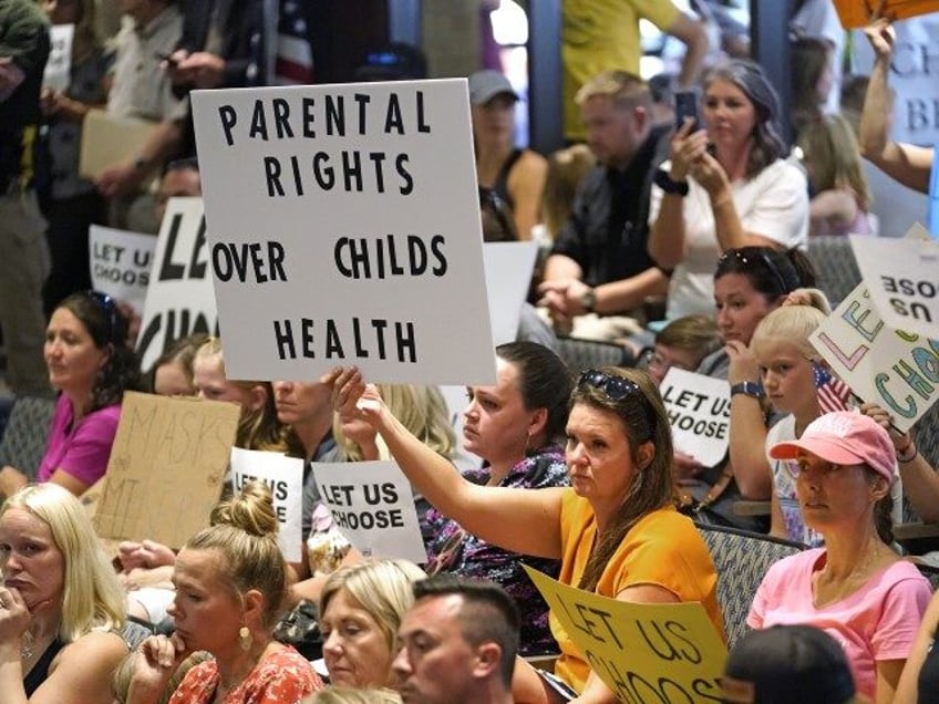 People listen to the Salt Lake County Council before their vote to overturned the health department's "order of restraint" on Thursday, Aug. 12, 2021, that would have required K-6 students to wear masks when school starts next week. (Rick Bowmer/AP)