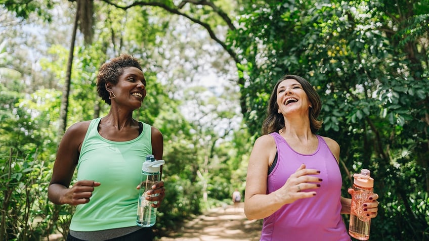 Friends talking and running in the park