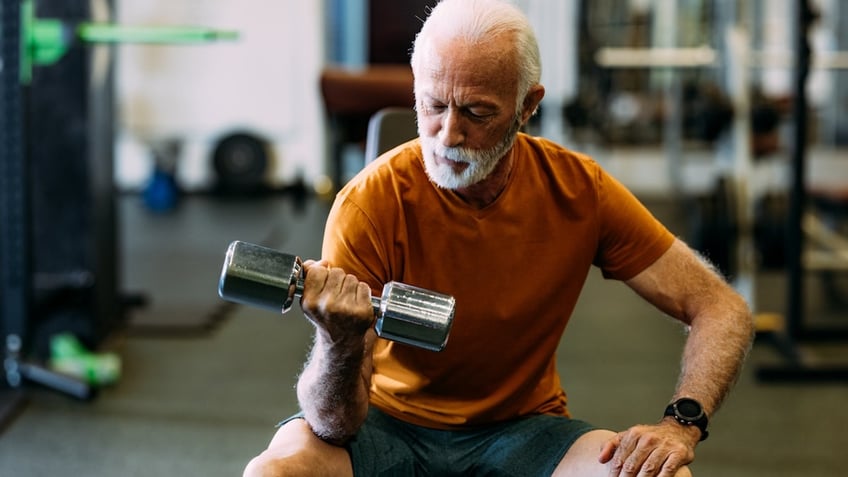 Older man lifting weights