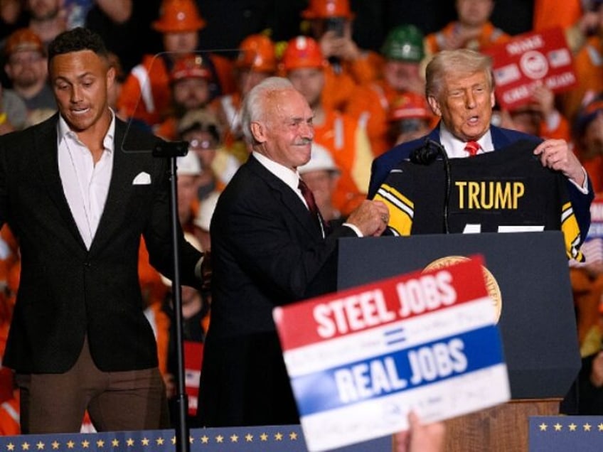 WEST MIFFLIN, PENNSYLVANIA - MAY 30: President Donald Trump receives a Pittsburgh Steeler
