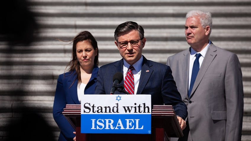 Johnson speaks as Stefanik listens on Capitol steps