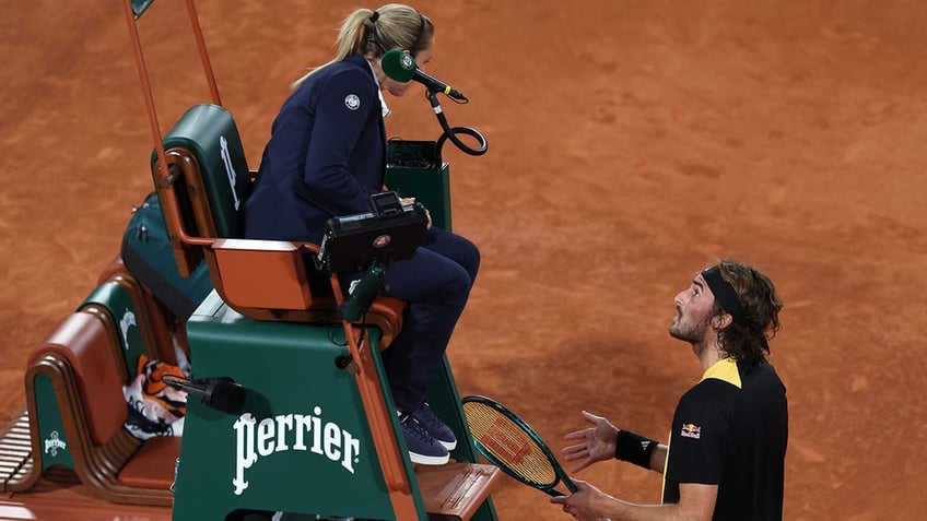 Stefanos Tsitsipas speaks to the chair umpire