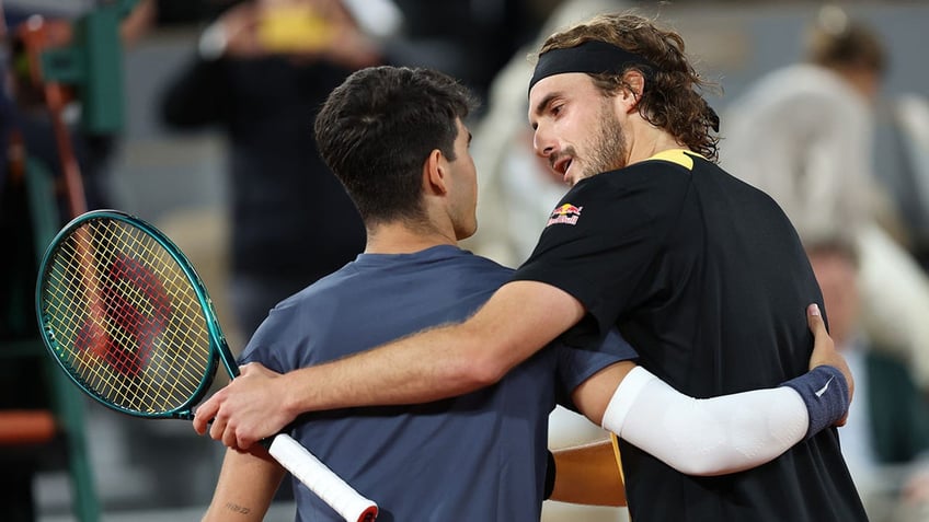 Stefanos Tsitsipas embraces Carlos Alcaraz