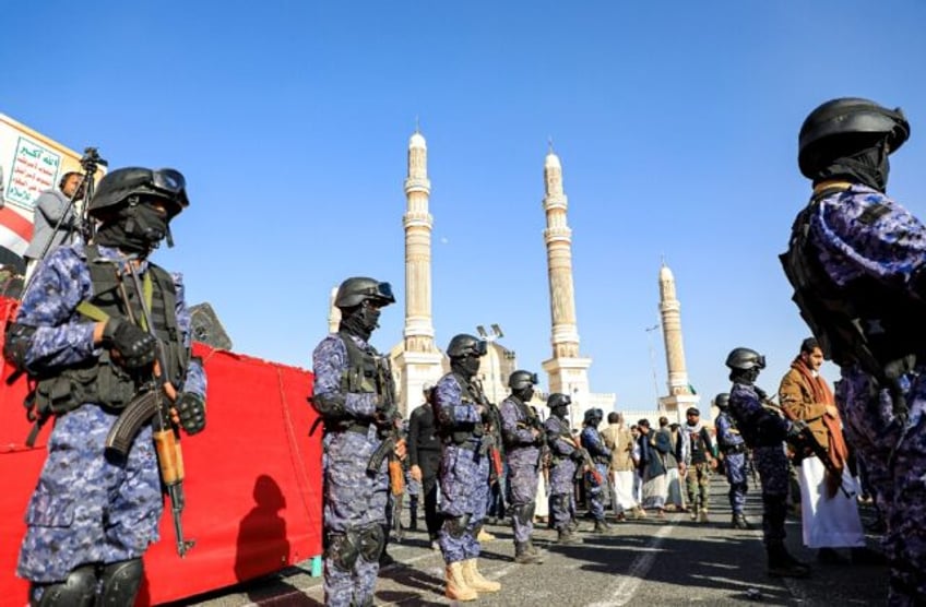 Yemen's Huthi-affiliated security forces stand guard during a march in solidarity with the people of Gaza in the capital Sanaa