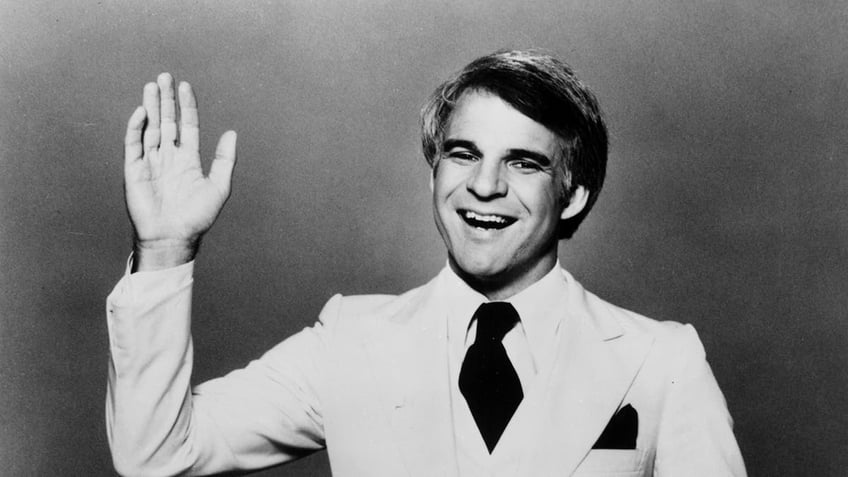 Black and white photo of Steve Martin waving