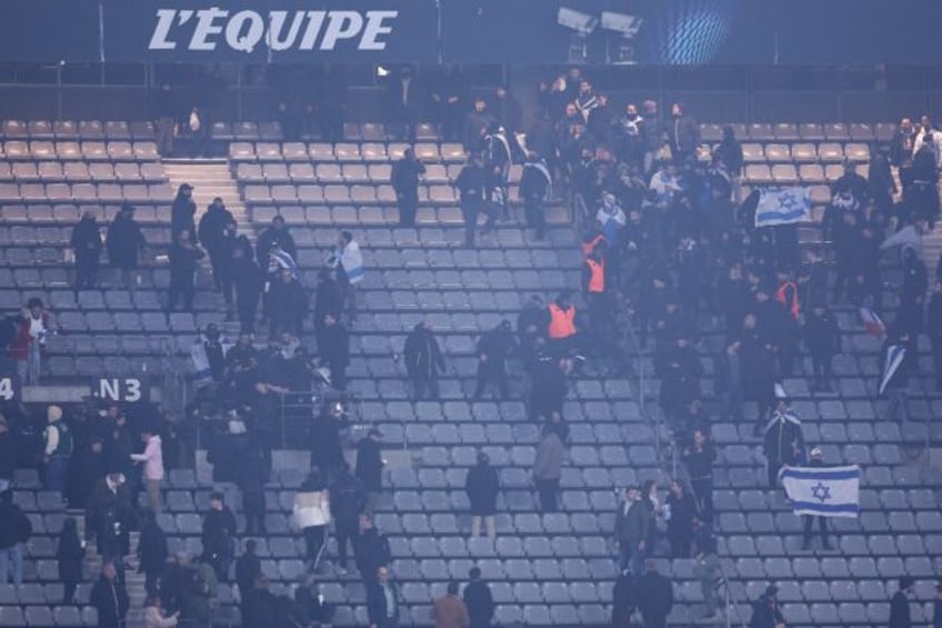 Stadium security staff intervene to stop Israel and France supporters from clashing at the